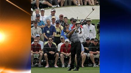 Spectators watch as Tiger Woods drives off the third tee during the first round of the Masters golf tournament in Augusta, Ga., Thursday, April 8, 2010. (AP Photo/Morry Gash)