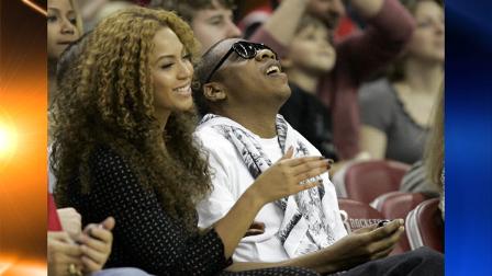 Beyonce Knowles, left, and rap-mogul Jay-Z watch a video during a timeout at the Houston Rockets basketball game against the Phoenix Suns Friday, April 11, 2008 in Houston. (AP Photo/Pat Sullivan)