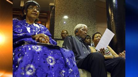 FILE - In this photo taken Thursday, Feb. 11, 2010 file photo, Winnie Madikizela-Mandela, left, alongside her former husband former President Nelson Mandela, centre, and his current wife Graca Machel attend the opening of Parliament in Cape Town, South Africa. Nelson Mandelas ex-wife denied Friday, March 12, 2010, that she had sharply criticized the anti-apartheid icon in a British newspaper interview, saying the comments attributed to her had been fabricated. (AP Photo/Schalk van Zuydaml, File)