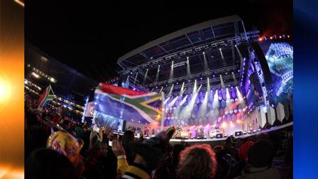 People wave South African flags as US-singer Fergie performs with her band Black Eyed Peas at the opening concert for the soccer World Cup at Orlando stadium in Soweto, South Africa, Thursday, June 10, 2010. The Soccer World Cup kicks off Friday, June 11. (AP Photo/Gero Breloer)
