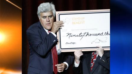 Entertainer Jay Leno jokes with Rich Westfall, right and hidden by oversized check, president of Gulf Coast Community Foundation about the money raised by Lenos one-night, one-show only benefit concert at the Beau Rivage Resort and Casino in Biloxi, Miss., Saturday, Aug. 21, 2010, for Mississippi oil spill victims. Leno said after looking at the over $90,000 collected in ticket sales, that he would contribute $10,000 to raise the amount to $100,000. (AP Photo/Rogelio V. Solis)