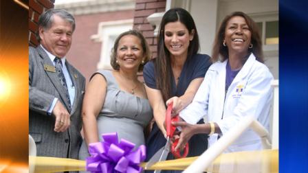 From left, Billy Hatchett, Warren Easton Foundation President, Alexina Medley, Principal, Sandra Bullock and school nurse Cassondra Ferrand cut the ribbon on an on campus health clinic at Warren Easton Charter High School in New Orleans Sunday Aug. 29, 2010, the five year anniversary of Hurricane Katrina. Bullock, The Kellogg Foundation and the San Francisco 49ers Foundation were the main financial contributors of the $700,000 facility. (AP Photo/Kerry Maloney)