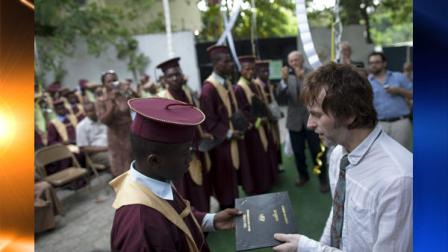 FILE - In this July 31, 2010 file photo, Guns N Roses musician Tommy Stinson, right, attends the graduation ceremony for former street youth at the Timkatec school in Port-au-Prince, Haiti. As he prepares to embark on a European tour with Guns N Roses, Stinson, 43, is devoting his time and money to a new passion: helping children left homeless by the Haitian earthquake. (AP Photo/Ramon Espinosa, File)