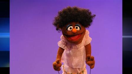In this publicity image released by Sesame Street, a brown muppet representing an African-American girl is shown during the taping of the I Love My Hair, video for the childrens program, Sesame Street.
Associated Press