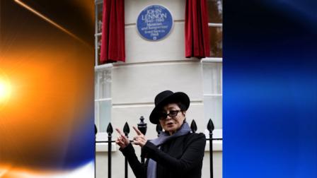 Japanese artist and musician Yoko Ono gestures as she poses in front of a Blue Plaque to honour British musician John Lennon during an unveiling ceremony at 34 Montagu Square in London, Saturday, Oct. 23, 2010. John Lennon is commemorated with an English Heritage blue plaque in celebration of his life and contribution to music at the flat where he shared his first home with Yoko Ono and where the famous nude photograph of John and Yoko was taken for the Two Virgins album cover. (AP Photo/Sang Tan)