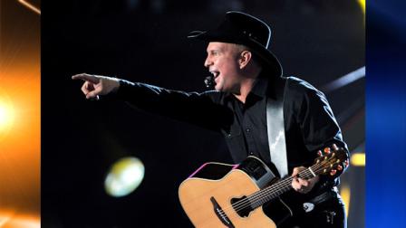 FILE - In this Jan. 25, 2008 file photo, country singer Garth Brooks performs during a charity concert in Los Angeles, to benefit the Southern California 2008 Fire Intervention Relief Effort (F.I.R.E). Brooks is going to be very busy in December. Brooks sold more than 140,000 tickets Saturday morning, Nov. 6, 2010, and his benefit concert for Nashville, Tenn., flood relief ballooned from one show to nine. (AP Photo/Mark J. Terrill, File)