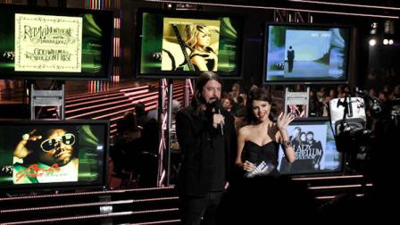 Dave Grohl, left, and Selena Gomez announce the nominees for song of the year at the Grammy Nominations Concert on Wednesday, Dec. 1, 2010, in Los Angeles. (AP Photo/Matt Sayles)