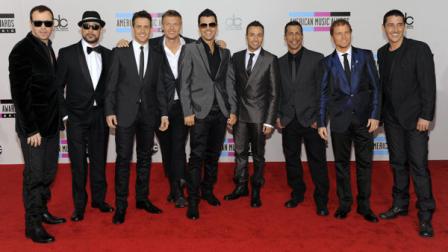 FILE - In this Nov. 21, 2010 file photo, members of the Backstreet Boys and New Kids on the Block, from left, Donnie Wahlberg, A. J. McLean, Joey McIntyre, Nick Carter, Jordan Knight, Howie Dorough, Danny Wood, Brian Thomas Littrell, and Jonathan Knight, arrive at the 38th Annual American Music Awards in Los Angeles. (AP Photo/Chris Pizzello, file)