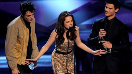 From left, Robert Pattinson, Kristen Stewart, and Taylor Lautner accept the award for favorite movie at the Peoples Choice Awards on Wednesday, Jan. 5, 2011, in Los Angeles. (AP Photo/Chris Pizzello)