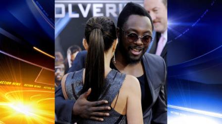 Will.i.am, right, a member of the music group Black Eyed Peas and a cast member in X-Men Origins: Wolverine, hugs Black Eyes Peas bandmate Fergie before an industry screening of the film in Los Angeles, Tuesday, April 28, 2009. (AP Photo/Chris Pizzello)
