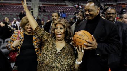 Aretha Franklin walks on the court with Jesse Jackson after the Detroit Pistons-Miami Heat NBA basketball game in Auburn Hills, Mich., Friday, Feb. 11, 2011. (AP Photo/Paul Sancya)