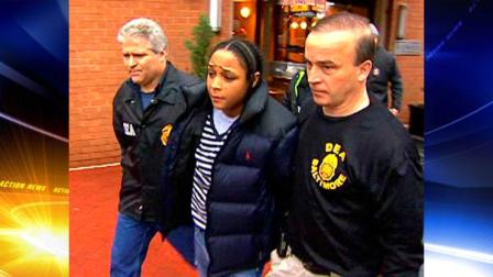 In this frame grab from video released by WBAL-TV 11, Drug Enforcement Administration agents escort Felicia Snoop Pearson, who played a killer of the same name on the hit HBO series The Wire, as she was among dozens arrested in an early morning drug raid, Thursday, March 10, 2011, in Baltimore. (AP Photo/WBAL-TV 11)