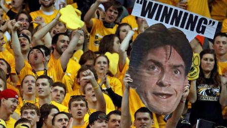 Fans hold a Charlie Sheen poster during the first half of the NCAA college Horizon League conference championship basketball game between Wisconsin-Milwaukee and Butler Tuesday, March 8, 2011, in Milwaukee. (AP Photo/Morry Gash)