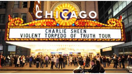 A motorcycle drives by the Chicago Theatre before Charlie Sheens performance, Sunday, April 3, 2011 in Chicago. Promising the real story, the 45-year-old former Two and a Half Men star continued his month-long, 20-city variety show tour, with Sundays sold-out show in Chicago. (AP Photo/Brian Kersey)