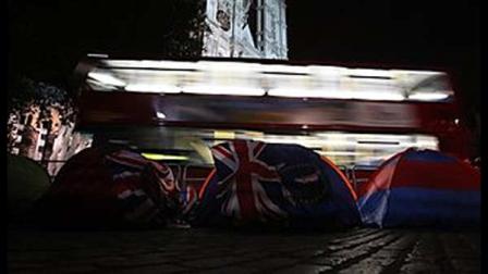 Fans of the British Royal family sleep in their tents outside Westminster Abbey, as a bus goes past in London , Wednesday, April, 27, 2011. Prince William is to marry Kate Middleton at Westminster Abbey in London, on Friday, April 29. (AP Photo/Alastair Grant)