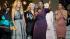 Oprah Winfrey speaks as she is surrounded by,...