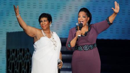 Aretha Franklin and Oprah Winfrey acknowledge fans during a star-studded double-taping of Surprise Oprah! A Farewell Spectacular, Tuesday, May 17, 2011, in Chicago. The Oprah Winfrey Show is ending its run May 25, after 25 years, and millions of her fans around the globe are waiting to see how she will close out a show that spawned a media empire. (AP Photo/Charles Rex Arbogast)