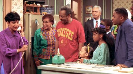 Phylicia Rashad, as Clair Huxtable, talks on the telephone while Bill Cosby, as Dr. Cliff Huxtable and other cast members of the family sitcom The Cosby Show gather around during taping of the final episode in New York City, Friday, March 6, 1992. From left clockwise are, Rashad; Clarice Taylor as Anna Huxtable; Cosby; Earl Hyman as Russel Huxtable; unidentified actor, partially hidden; Malcolm Jamal Warner as Theo; Keshia Knight Pulliam as Rudy; and Raven Symone as Olivia. (AP Photo)