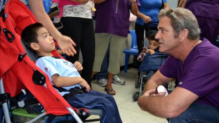 In this image released by San Juan De Dios General Hospital, actor Mel Gibson, right, speaks with a young patient at the San Juan De Dios General Hospital in Guatemala City, Wednesday June 8, 2011. Gibson visited patients at the hospital where he will help fund the Spina Bifida Unit. (AP Photo/Rony Veliz, San Juan De Dios Hospital)