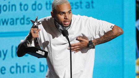 Chris Brown accepts the award for best male R&B artist at the BET Awards on Sunday, June 26, 2011, in Los Angeles. (AP Photo/Matt Sayles)