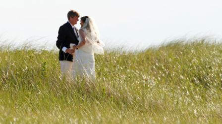 Former U.S. Rep. Patrick Kennedy, D-R.I., the son of the late U.S. Sen. Edward Kennedy, walks through the beach grass with his wife Amy Petitgout after their wedding ceremony at the Kennedy Compound in Hyannisport, Mass., Friday, July 15, 2011. (AP Photo/Charles Krupa)