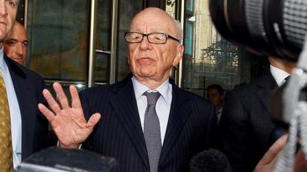 Rupert Murdoch, centre, attempts to speak to the media after he held a meeting with the parents and sister of murdered school girl Milly Dowler in London, Friday, July 15, 2011. (AP Photo/Kirsty Wigglesworth)