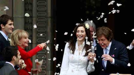 American broadcast journalist and author Barbara Walters throws rose petals as former Beatle Sir Paul McCartney and his wife American heiress Nancy Shevell leave Marylebone Registry Office, following their wedding in central London , Sunday Oct. 9, 2011. Shevell, 51, is McCartneys third wife.The couple met in the Hamptons in Long Island, New York, shortly after the singers divorce from Heather Mills in 2008 and they were engaged earlier this year. (AP Photo/Lefteris Pitarakis)