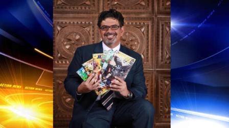 In this image released by Teshkeel Media Group, comic book author Naif Al-Mutawa holds up copies of his comic book series The 99, on Long Island, N.Y.