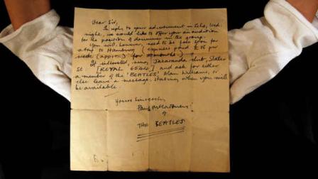 A Christies employee displays a letter inviting an unknown drummer to audition for The Beatles, at their auction house in London, Monday, Oct. 17, 2011. The handwritten letter by Paul McCartney, dated 12 August 1960, inviting an unknown drummer to audition for The Beatles, was discovered folded-up inside a book, by an anonymous collector at a car boot sale in Bootle, Liverpool, England. It is expected to sell at auction for 7,000-9,000 pounds (11,050- 14,200 US dollars).