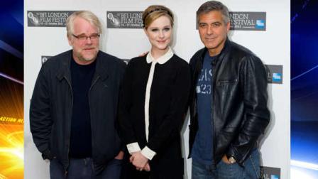 From left, U.S actor Philip Seymour Hoffman, U.S actress Evan Rachel Wood and U.S director George Clooney pose during the photocall for The Ides of March at a central London Cinema, Wednesday, Oct. 19, 2011.