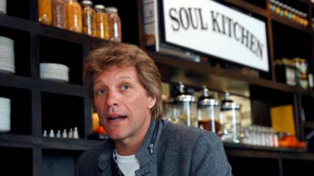 Rock star Jon Bon Jovi sits in the Soul Kitchen restaurant in Red Bank, N.J., Wednesday, Oct. 19, 2011, during the opening of the restaurant which is designed to help the hungry without the stigma of a soup kitchen. Diners pay whatever theyre able to.