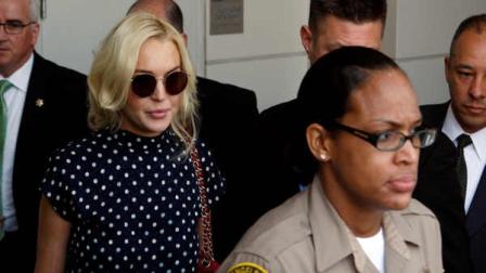 Actress Lindsay Lohan leaves a probation hearing at Los Angeles Superior Court Wednesday, Nov. 2, 2011. Superior Court Judge Stephanie Sautner sentenced Lohan on Wednesday to 30 days in jail and warned the actress there would be plenty more time behind bars if she violated further court orders.