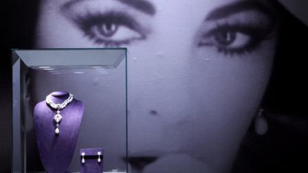 La Peregrina, left, a Natural Pearl, Diamond and Ruby necklace by Cartier, and a pair of Natural Pearl and Diamond ear pendants by Bulgari are on display during a preview of the full Collection of Elizabeth Taylor at Christies, Thursday, Dec. 1, 2011 in New York. The collection will be up for auction in person and online, a first for Christies, from Dec. 13-17. (AP Photo/Mary Altaffer)