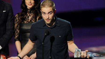 Robert Pattinson accepts the award for favorite drama movie for Water for Elephants during the Peoples Choice Awards on Wednesday, Jan. 11, 2012 in Los Angeles. Looking Ashley Greene. (AP Photo/Chris Pizzello)