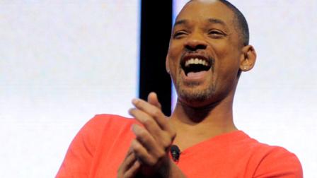 Actor Will Smith laughs after viewing a Men in Black 3 movie trailer during a Sony news conference at the 2012 International CES in Las Vegas, Monday, Jan. 9, 2012. (AP Photo/Jack Dempsey)