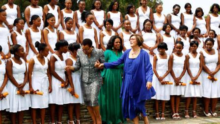 Nelson Mandelas wife Graca Machel, center left, holds school principal Ann Van Zyls hand as they leave a photo opportunity with graduates and Oprah Winfrey, centre wearing green, after the first graduation ceremony at Oprah Winfreys leadership academy for girls in Henley on Klip, South Africa, Saturday Jan. 14, 2012. Winfrey said the first students to graduate from her academy for underprivileged South African girls were free to soar, during a graduation speech Saturday.(AP Photo/Jerome Delay)