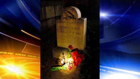 A flashlight shines on items left on the gravestone of Edgar Allen Poe by people who pretended to be the mysterious Poe Toaster in Baltimore, early Thursday, Jan. 19, 2012. Fans waited long past a midnight dreary to see if the true Poe Toaster would return after a two-year hiatus to leave cognac and roses upon the writers grave on the anniversary of his birth, or whether the tradition had reached an end. The Poe Toaster was a no-show for a third year. (AP Photo/Patrick Semansky)