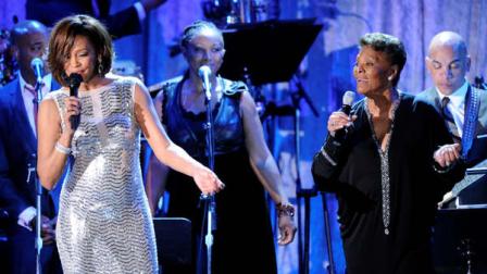 Singer Whitney Houston, left, performs with Dionne Warwick at the pre-Grammy gala and salute to industry icons with Clive Davis honoring David Geffen, Sunday, Feb. 13, 2011, in Beverly Hills, Calif. (AP Photo/Mark J. Terrill)