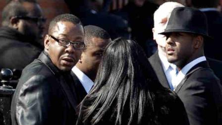 Singer Bobby Brown, left, is seen outside during the funeral of his ex-wife Whitney Houston at New Hope Baptist Church in Newark, N.J., Saturday, Feb. 18, 2012. (AP Photo/Mel Evans)