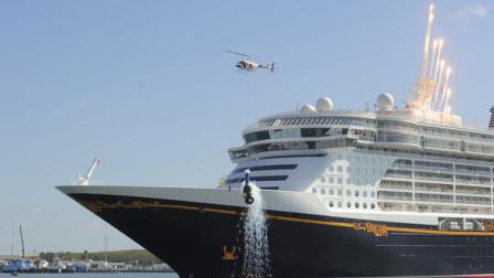 In this photo provided by Disney, a helicopter breaks an oversized replica of a Champagne bottle on the bow of the new Disney Dream cruise ship Wednesday, Jan. 19, 2011 in Port Canaveral, Fla., during the christening ceremony for the 130,000-ton, 4,000 passenger ship. Its the newest Disney Cruise Line ship and will sail three-, four- and five-night cruises to the Bahamas beginning with its maiden voyage on Jan. 26, 2011. (AP Photo/Disney, Scott Miller)