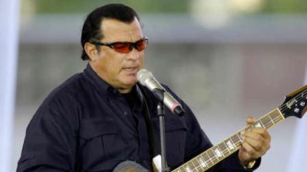 American actor Steven Seagal plays in a charity concert organized by the Federation charity in Moscow, Russia, Sunday, July 10, 2011. Federation held a charity ball last year with Prime Minister Vladimir Putin performing on the piano. (AP Photo/Misha Japaridze)