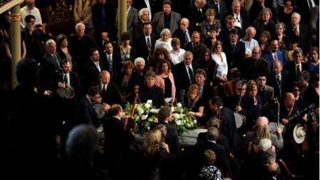 The casket of Earl Scruggs passes an honor guard of banjo players during the funeral service for the banjo great and bluegrass pioneer at the Ryman Auditorium on Sunday, April 1, 2012, in Nashville, Tenn. Scruggs died Wednesday, March 28, 2012. He was 88. (AP Photo/Joe Howell, Pool)