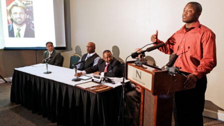 Christopher Johnson, right, answers questions at a news conference as pictures of contestants from the television show The Bachelor are shown on a screen at left on Wednesday, April 18, 2012, in Nashville, Tenn. Johnson and Nathaniel Claybrooks are taking The Bachelor and The Bachelorette to court with a lawsuit that claims the reality shows are blocking contestants of color from starring roles. Both men applied to be contestants on The Bachelor. ( AP Photo/Mark Humphrey)