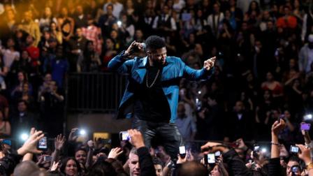 Usher makes a guest appearance during a Romeo Santos concert at Madison Square Garden, Friday, Feb. 24, 2012 in New York. (AP Photo/Jason DeCrow)