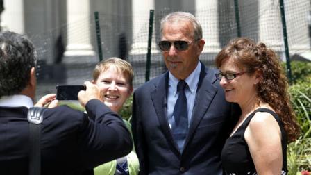 Actor Kevin Costner poses for photos with Krista Armstrong, right, and Kasey Cummings, as he leaves Federal Court for a lunch break in New Orleans, Monday, June 4, 2012. Stephen Baldwin has sued Costner over their investments in a device that BP used in trying to clean up the massive Gulf of Mexico oil spill. The federal lawsuit filed in New Orleans by Baldwin and a friend claims Costner and a business partner duped them out of their shares of an $18 million deal for BP to purchase oil-separating centrifuges from a company they formed after the April 20 spill. ( AP Photo/Bill Haber)