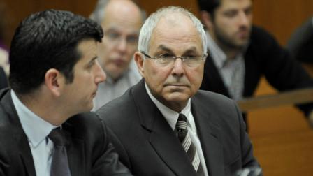Peter Madoff consults with his attorney Charles Spada before judge Stephen Bucaria at Mineola State Supreme Court, Friday, April 3, 2009, in New York. The former chief compliance officer of Bernard Madoff investment Securities LLC and brother of Bernard will be allowed to spend $10,000 a month for living expenses under an agreement reached Friday between attorneys in a lawsuit accusing him of swindling a college student. (AP Photo/ Louis Lanzano, POOL),