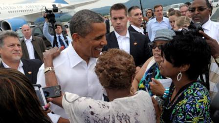 President Barack Obama greets people after arriving at Roanoke Regional Airport in Roanoke, Va., Friday, July 13, 2012. Obama is spending the day campaigning in Virginia. (AP Photo/Susan Walsh)