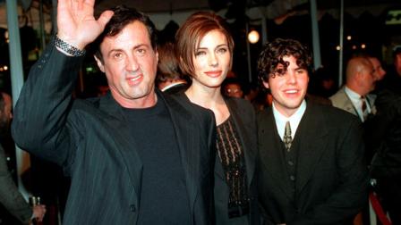 FILE - In this Dec. 5, 1996 file photo, Sylvester Stallone, left, star of the film Daylight, arrives at the films world premiere with his girlfriend Jennifer Flavin, center, and his son Sage Stallone, who co-stars in the film, in Hollywood district of Los Angeles. A publicist for Sylvester Stallone says the actors son, Sage Stallone has died on Friday, July 13, 2012, at age 36. (AP Photo/Kevork Djansezian, File)