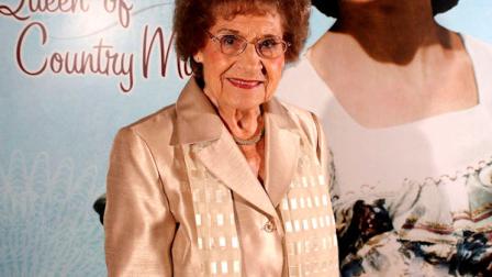 FILE - This Aug. 14, 2008 file photo originally released by the Country Music Hall of Fame and Museum shows music pioneer Kitty Wells at an exhibit honoring her career in Nashville, Tenn. Wells, the first female superstar of country music, has died at the age of 92. The singers family says Wells died at her home Monday after complications from a stroke. Her recording of It Wasnt God Who Made Honky Tonk Angels in 1952 was the first No. 1 hit by a woman soloist on the country music charts. Other hits included Making Believe and a version of I Cant Stop Loving You. (AP Photo/Country Music Hall of Fame and Museum, Donn Jones, file)