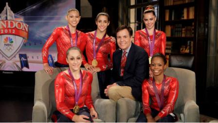 This Tueday, July 31, 2012 photo released by NBC shows the US Womens Gymnastics team, winners of the gold medal for womens team gymnastics, Kyla Ross, standing left, Jordyn Wieber, seated left, Aly Raisman, standing center, McKayla Maroney, and Gabby Douglas, seated right, with NBC Sports Bob Costas in London. NBC is set to break even on its Olympics coverage, rather than lose money as previously expected, the head of NBCUniversal said Wednesday, Aug. 1. The company had expected at one point to take a $200 million loss on the London Olympics. NBC paid $1.2 billion for the rights to show the games on TV and online in the U.S. It has said that it sold more than $1 billion in ads, breaking the record of $850 million set during the Beijing Olympics in 2008. (AP Photo/NBC, Paul Drinkwater)